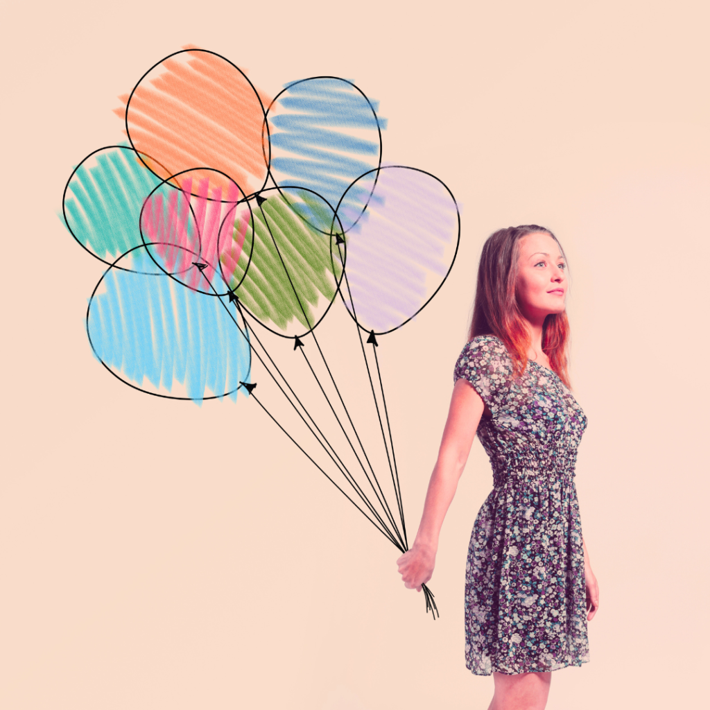 Real life woman holding a bouquet of drawn balloons that are colored in roughly.